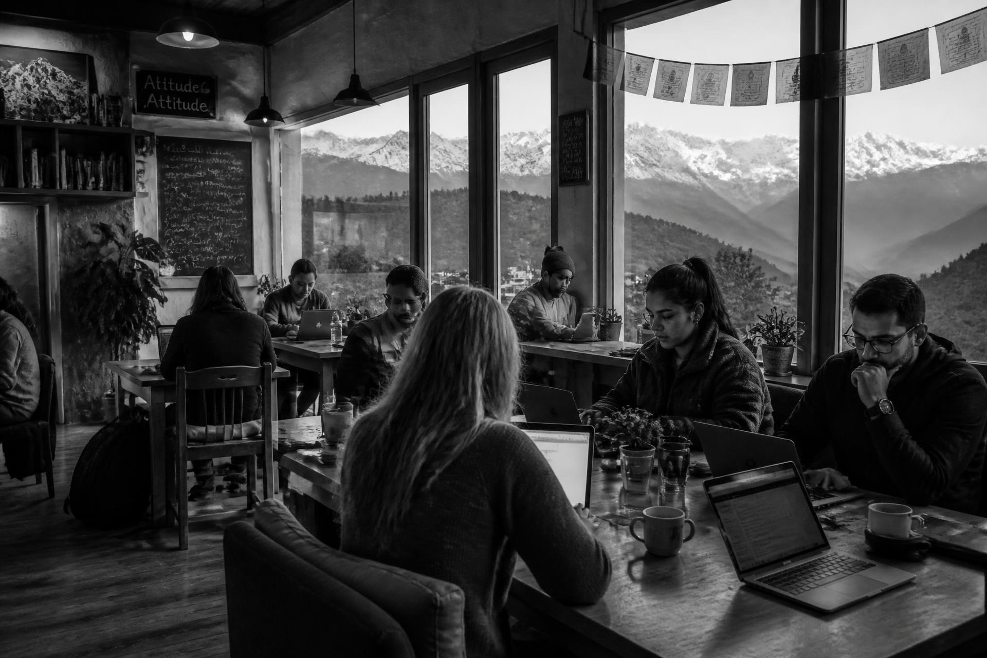 Remote professionals working from a café in the mountains